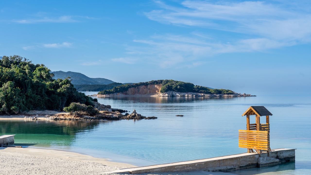 Ksamil's white beach, clear water and green islets on the Albanian Riviera