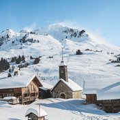 Courchevel in winter, its chapel and chalets below the snow