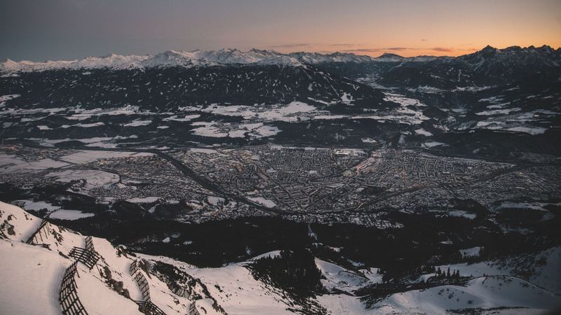 Innsbruck and the Inn valley in snow at dusk, seen from the Nordkette