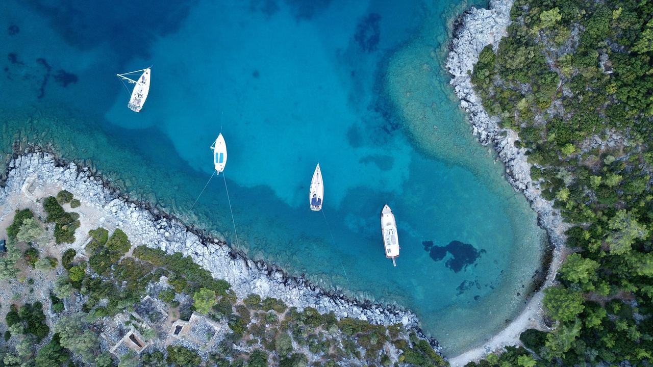 Boats at anchor in a clear bay near Bodrum, Türkiye