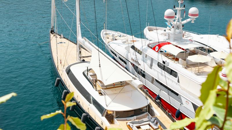 A sailing yacht and a superyacht moored side by side, from above, Port Hercule