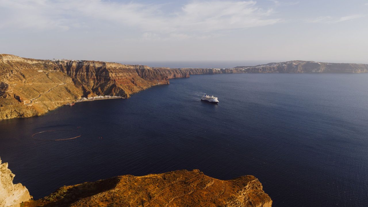 A cruise ship crossing the caldera of Santorini below the cliffs