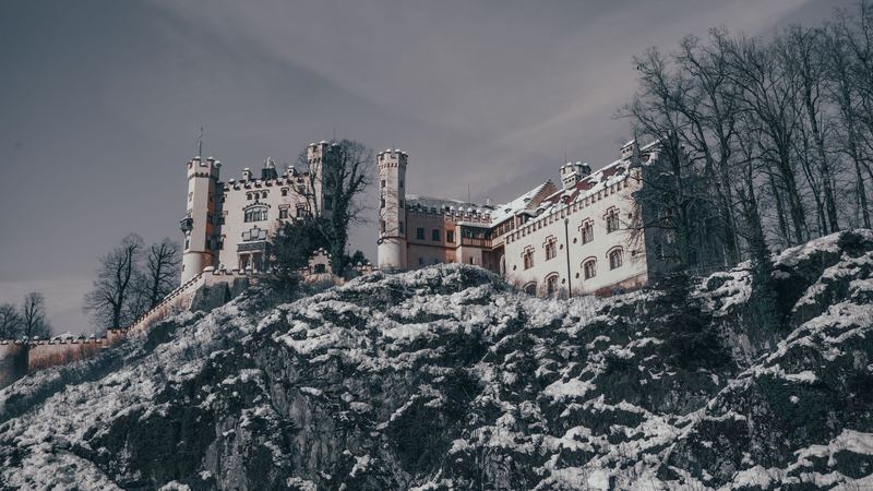 Hohenschwangau Castle on its rock in the snow, near Füssen
