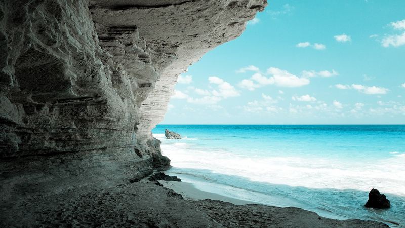 A turquoise sea and white surf below a limestone overhang at Ageeba Beach near Marsa Matruh