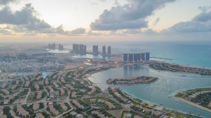 Lagoons, villas and new towers along the North Coast at New Alamein at dusk, seen from the air