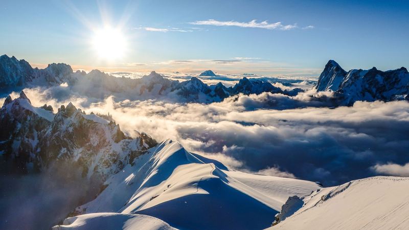 Sunrise over a sea of cloud and the snow ridge of the Aiguille du Midi