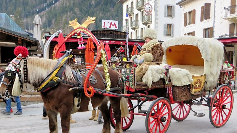 A horse-drawn carriage lined with white fur in the centre of Chamonix, its driver in a fur hat