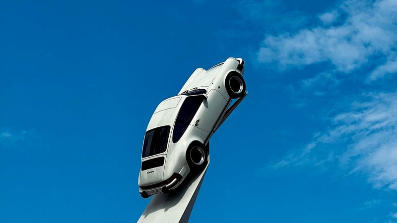 A Porsche 911 raised on its pillar at the Porsche Museum, Stuttgart-Zuffenhausen