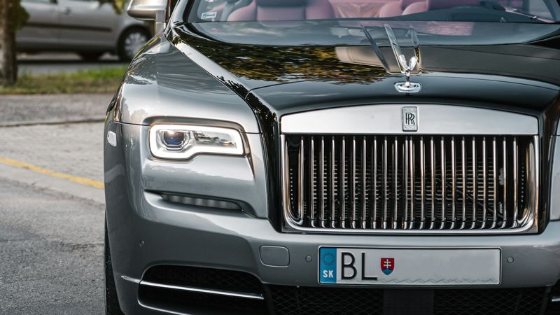 A Rolls-Royce Dawn convertible, roof down, in evening light