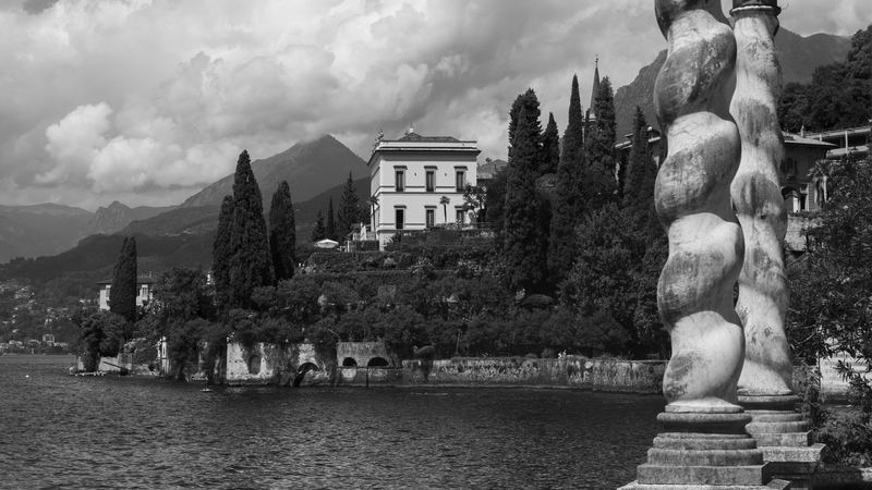 Villa Monastero and its cypresses on the shore of Lake Como, with twisted marble columns, in black and white