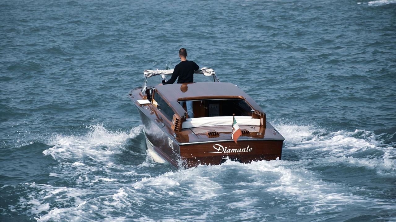 A classic wooden motor launch at speed