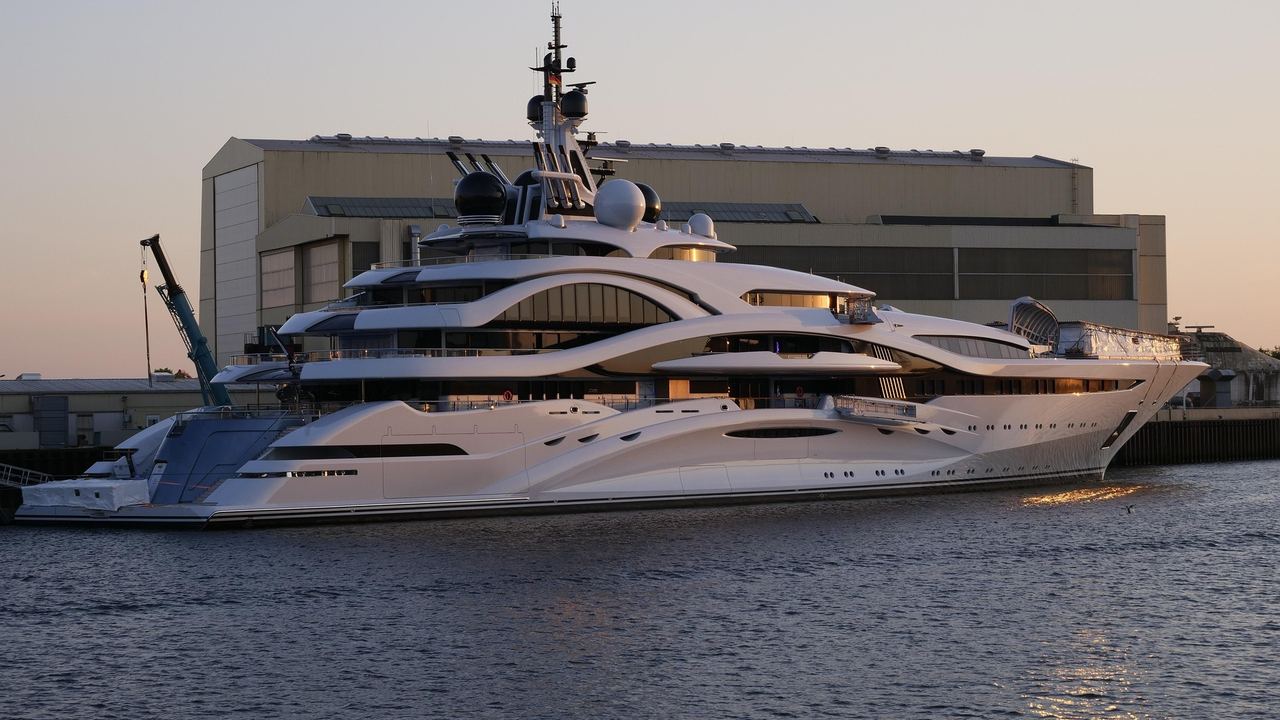 A superyacht alongside the yard at sunset