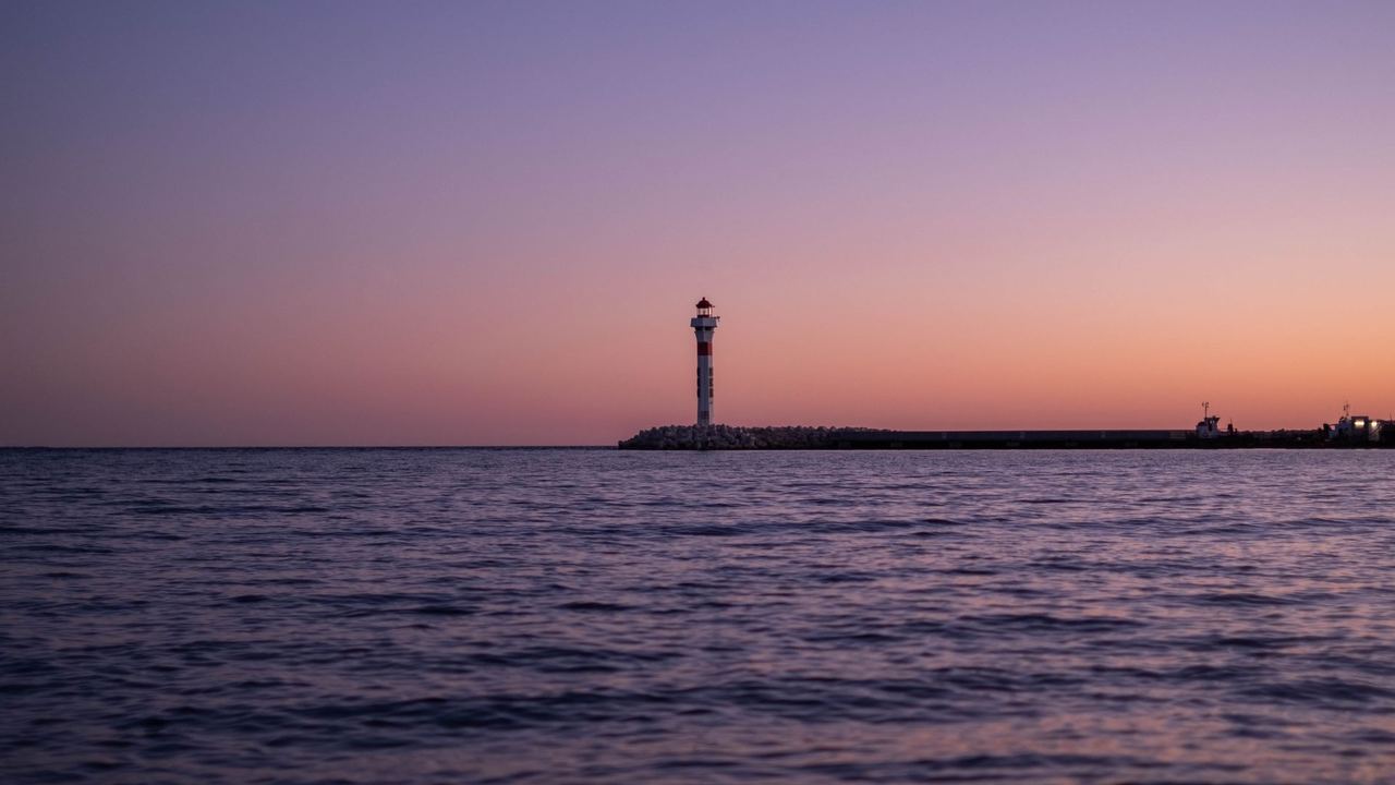 A lighthouse on a breakwater at dusk, Dénia