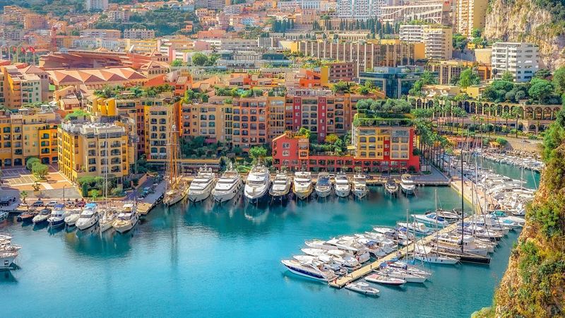 The marina of Fontvieille below its ochre and red apartments and the Tête de Chien, from the Rock