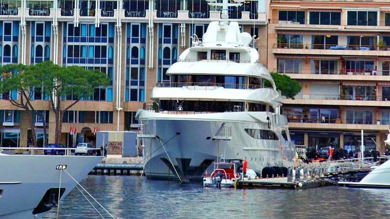 A superyacht moored in Port Hercule below the grand hotels and terraces of Monte-Carlo