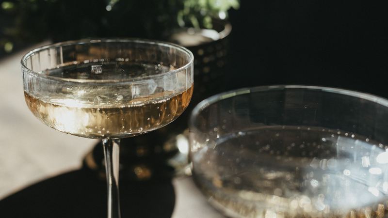 Two crystal coupes of champagne in the afternoon sun