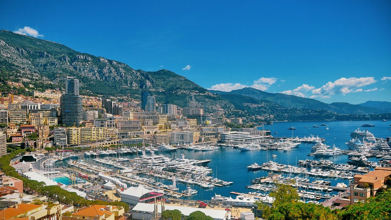 Port Hercule filled with yachts below Monte-Carlo and the mountains, Monaco
