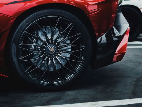 The forged wheel and carbon-ceramic brakes of a red Lamborghini Aventador SV