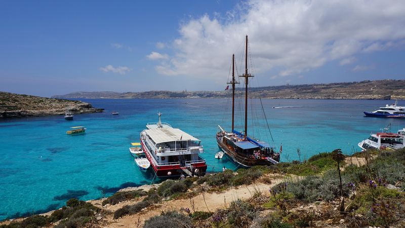 The turquoise water of the Blue Lagoon at Comino, with Gozo on the horizon