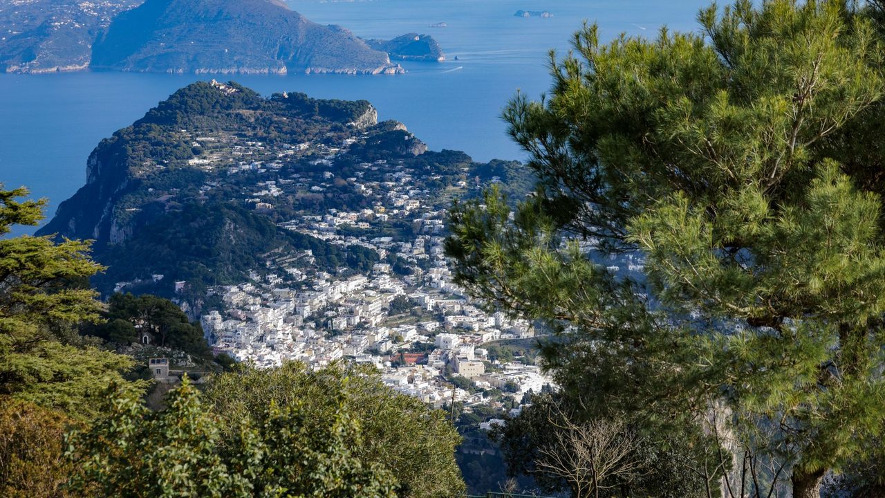 Capri town and the island from Monte Solaro, the Sorrento peninsula and the Amalfi Coast beyond