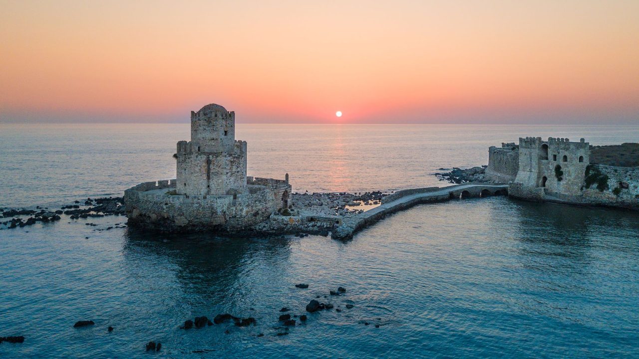 The Bourtzi tower of Methoni Castle at sunset, its stone causeway over the sea, Messinia
