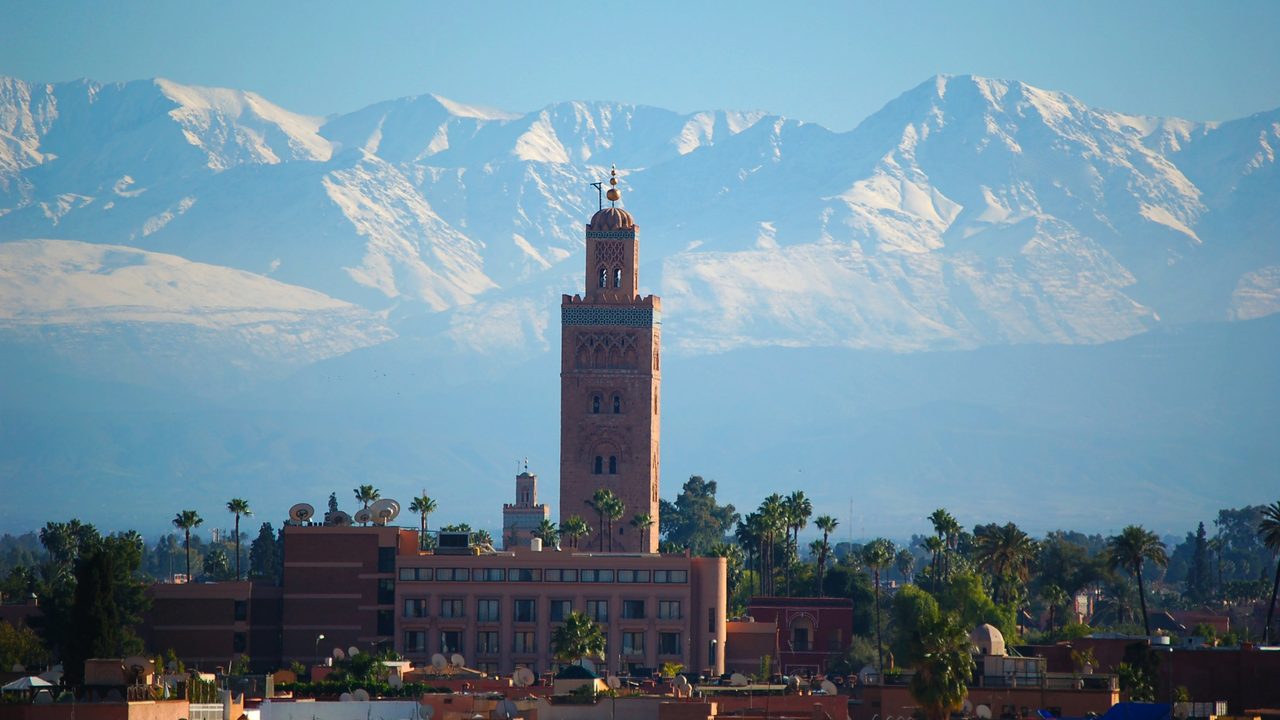 The Koutoubia minaret against the snow-capped High Atlas