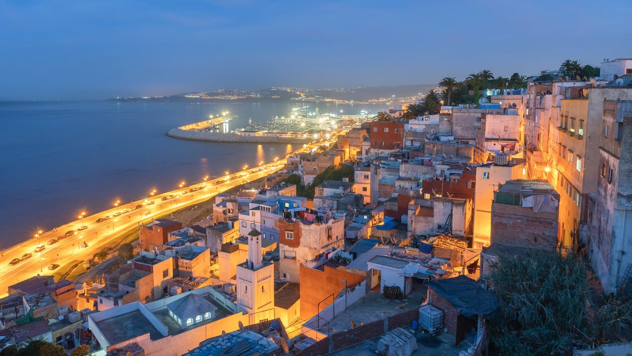 The white medina of Tangier above the bay and port at blue hour