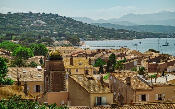 The rooftops and bell tower of Saint-Tropez above the bay