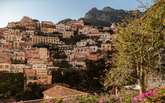 The pastel houses of Positano climbing the cliffs in the evening sun