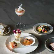 Plates of a tasting menu on a stone table