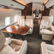 The cream leather cabin of a private jet