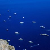 Superyachts at anchor in the deep blue sea off Capri