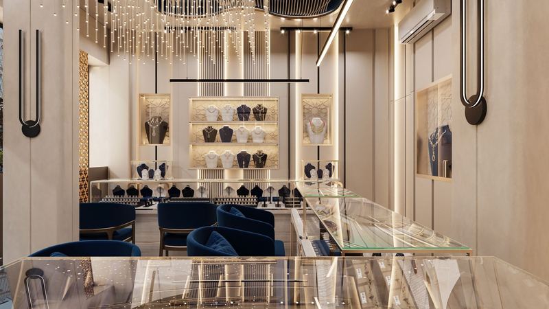 A jeweller’s salon with necklaces on lit shelves, glass cases and blue velvet chairs below a crystal chandelier