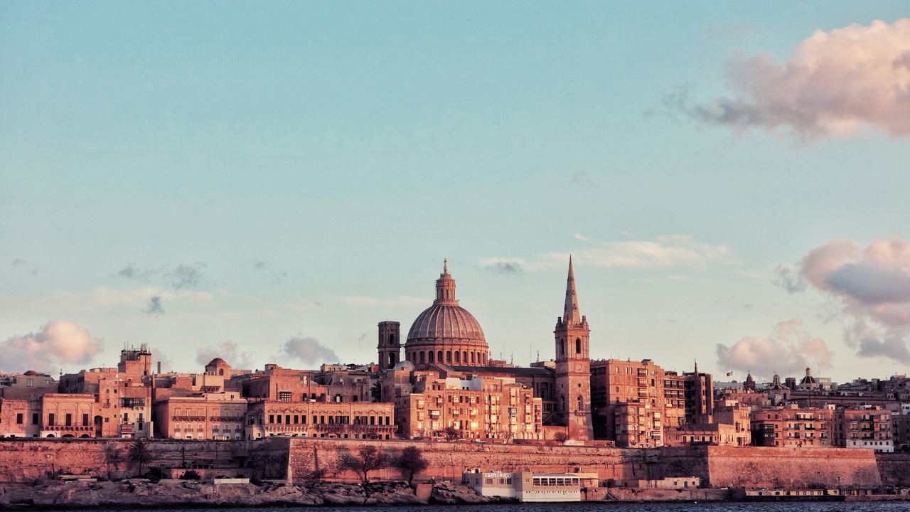 Valletta's dome and spire at sunset, Malta